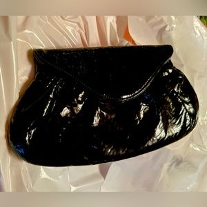 Black patent Lauren Merkin clutch bag with a shoulder length chain.